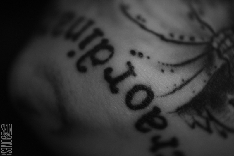 A macro image of my friends arm tattoo in black and white - focussed on the words in her arm